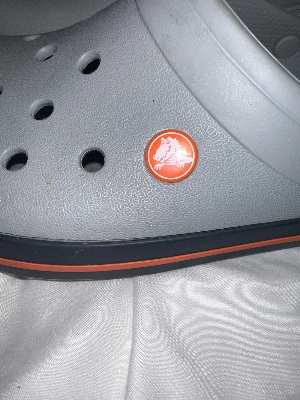 Crocs Crocband Unisex-Clogs in the light grey/navy/orange colorway. (11016-01U.)